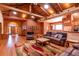 Spacious living room with wood floors, beamed ceilings, and comfortable leather furniture adjacent to the dining area at 6928 Cozumel Ct, Land O Lakes, FL 34637
