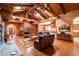 Open concept living room with fireplace, wood floors, beamed ceilings, skylights and a view to the dining area at 6928 Cozumel Ct, Land O Lakes, FL 34637