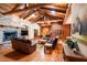 Cozy living room featuring wood floors, a fireplace, and exposed beam ceilings at 6928 Cozumel Ct, Land O Lakes, FL 34637