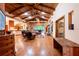 Spacious living room featuring wood floors, exposed beam ceilings, and a fireplace at 6928 Cozumel Ct, Land O Lakes, FL 34637