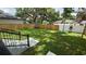 View of the expansive backyard from the patio featuring a well-maintained lawn and wood privacy fence at 7011 N 15Th St, Tampa, FL 33610