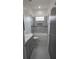 Bright bathroom features shower over tub, tiled walls, and modern vanity at 7011 N 15Th St, Tampa, FL 33610
