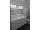 Modern bathroom with dual sinks, sleek vanity, and a glass-enclosed shower for a spa-like experience at 7011 N 15Th St, Tampa, FL 33610