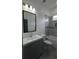 Bathroom with modern vanity, bright lighting, and shower over tub at 7011 N 15Th St, Tampa, FL 33610