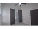 Bedroom with gray closet doors, modern ceiling fan, and attached bath at 7011 N 15Th St, Tampa, FL 33610