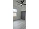 Bedroom with modern ceiling fan, gray closet doors, and bright window at 7011 N 15Th St, Tampa, FL 33610