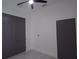 Bedroom with gray closet doors, modern ceiling fan and bright windows at 7011 N 15Th St, Tampa, FL 33610