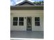 Close-up view of modern front door with glass, sleek architectural details, and a well-maintained exterior at 7011 N 15Th St, Tampa, FL 33610