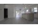 Spacious kitchen showcasing a central island, modern fixtures, and seamlessly flowing into the living area at 7011 N 15Th St, Tampa, FL 33610