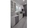 Modern kitchen featuring white cabinets, stainless steel appliances, and sleek countertops at 7011 N 15Th St, Tampa, FL 33610