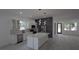 Bright kitchen featuring stainless steel appliances, shaker cabinets, and an island with pendant lighting at 7011 N 15Th St, Tampa, FL 33610
