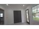 Modern living space with a neutral palette and wood-look flooring, highlighted by recessed lighting at 7011 N 15Th St, Tampa, FL 33610