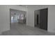Bright, open-concept living area with modern gray accents, sleek flooring, and a view to the kitchen at 7011 N 15Th St, Tampa, FL 33610
