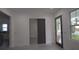 Contemporary living room with wood-look flooring and a view of another room through a sliding door at 7011 N 15Th St, Tampa, FL 33610