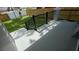 The patio features black railings, and steps leading down to a grassy backyard with wood and white fences at 7011 N 15Th St, Tampa, FL 33610
