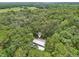 Secluded home nestled in a lush, green forest with open fields in the distance at 7189 Griffin Rd, Brooksville, FL 34601