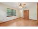 Bedroom features tile flooring, a closet, ceiling fan, and ample natural light at 7189 Griffin Rd, Brooksville, FL 34601