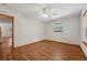Bright bedroom with wood look floors, ceiling fan, and natural light at 7189 Griffin Rd, Brooksville, FL 34601