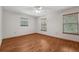 Spacious bedroom featuring wood floors, natural light, and neutral paint at 7189 Griffin Rd, Brooksville, FL 34601
