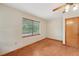 Bedroom with tile flooring, a window, wooden closet door, and ample natural light at 7189 Griffin Rd, Brooksville, FL 34601