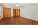 Large bedroom with wood look floors, a ceiling fan, natural light, and ample closet space at 7189 Griffin Rd, Brooksville, FL 34601