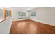 Upstairs bonus room with wood look floors and natural light from multiple windows at 7189 Griffin Rd, Brooksville, FL 34601