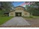 House exterior with a covered carport and long driveway, perfect for parking at 7189 Griffin Rd, Brooksville, FL 34601