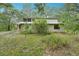 Two story exterior of this home with a covered front porch and a metal roof at 7189 Griffin Rd, Brooksville, FL 34601
