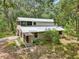 Charming two-story home with a metal roof and verdant landscaping at 7189 Griffin Rd, Brooksville, FL 34601