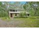 Charming two-story home nestled among mature trees and lush greenery at 7189 Griffin Rd, Brooksville, FL 34601