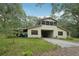 Two story exterior of this home with a drive through carport and upper screened porch at 7189 Griffin Rd, Brooksville, FL 34601