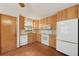 Bright kitchen with wood cabinets, white appliances, window over sink at 7189 Griffin Rd, Brooksville, FL 34601