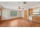 Bright eat-in kitchen with wood cabinets, white appliances, and big window at 7189 Griffin Rd, Brooksville, FL 34601