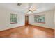 Bright living room with wood look floors, natural light, and a door leading to the outside at 7189 Griffin Rd, Brooksville, FL 34601