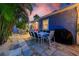 Outdoor dining area with a stone patio and seating for eight, perfect for entertaining at 722 Gulf Blvd, Indian Rocks Beach, FL 33785
