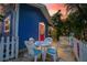 Quaint backyard featuring a dining set, white picket fence, and tropical greenery at 722 Gulf Blvd, Indian Rocks Beach, FL 33785