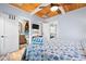 Charming bedroom with wood ceiling, TV, and view of the ensuite bathroom and open doorway to a seating area at 722 Gulf Blvd, Indian Rocks Beach, FL 33785