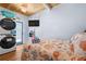 This bedroom includes a television, laundry, and access to an exterior patio at 722 Gulf Blvd, Indian Rocks Beach, FL 33785