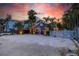 Charming blue beach house with a white picket fence and lush tropical landscaping at 722 Gulf Blvd, Indian Rocks Beach, FL 33785
