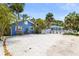 Charming blue beach houses with white picket fences and lush tropical landscaping at 722 Gulf Blvd, Indian Rocks Beach, FL 33785