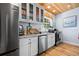 Bright kitchen with white cabinetry, stainless appliances, and a marble backsplash at 722 Gulf Blvd, Indian Rocks Beach, FL 33785