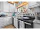 This kitchen features granite counters, stainless steel appliances, and updated cabinets at 722 Gulf Blvd, Indian Rocks Beach, FL 33785
