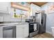 Kitchen area featuring updated appliances, granite counters, and ample cabinet space at 722 Gulf Blvd, Indian Rocks Beach, FL 33785