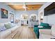 Inviting living room with cozy seating, wood ceilings, and an open floor plan at 722 Gulf Blvd, Indian Rocks Beach, FL 33785