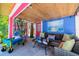 Cozy patio with wicker sofa, beach-themed decor, and outdoor string lights at 722 Gulf Blvd, Indian Rocks Beach, FL 33785