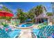 Backyard with inground pool, lounge chairs, and tropical landscaping creates a relaxing outdoor oasis at 722 Gulf Blvd, Indian Rocks Beach, FL 33785