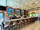 Upscale bar with a marble countertop, stylish seating, and multiple windows for natural light at 746 Masterpiece Dr, Sun City Center, FL 33573