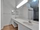 Large bathroom with double sinks and an oversized mirror at 746 Masterpiece Dr, Sun City Center, FL 33573