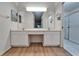Bathroom featuring a double vanity, ample counter space, and a shower at 746 Masterpiece Dr, Sun City Center, FL 33573