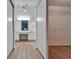 Bathroom with double vanity, wood-look floors, and bright lighting at 746 Masterpiece Dr, Sun City Center, FL 33573